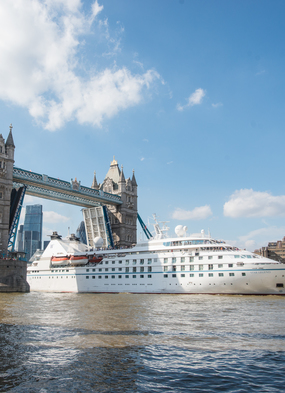 Windstar's Star Legend cruises the Thames river, passing under Tower Bridge