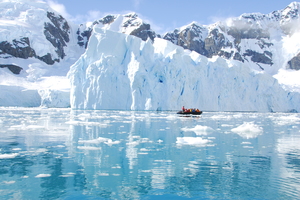 Zodiac cruising past icebergs in Antarctica